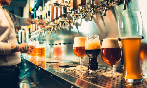 Glass of beer with barrel, bottle and fresh hops still-life היי בר - High Bar